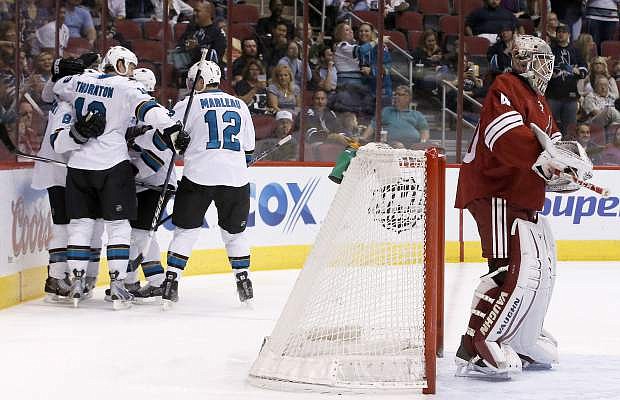 San Jose Sharks&#039; Joe Pavelski (8) celebrates his goal against Phoenix Coyotes&#039; Mark Visentin, right, with teammates, including Joe Thornton, second from left, and Patrick Marleau (12), during the first period of an NHL hockey game on Saturday, April 12, 2014, in Glendale, Ariz. (AP Photo/Ross D. Franklin)