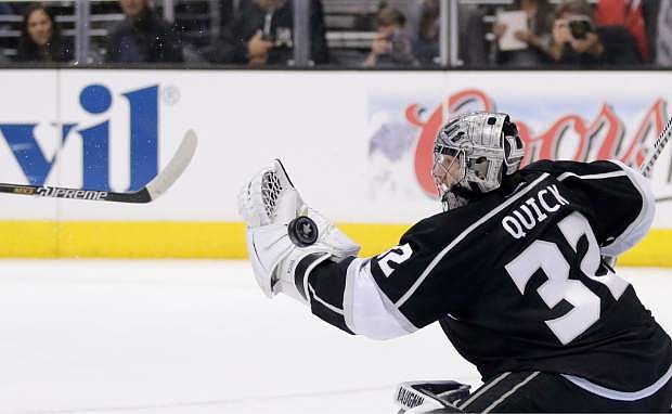 Los Angeles Kings goalie Jonathan Quick blocks a shot from the San Jose Sharks during the first period in Game 4 of an NHL hockey first-round playoff series in Los Angeles, Thursday, April 24, 2014. (AP Photo/Chris Carlson)