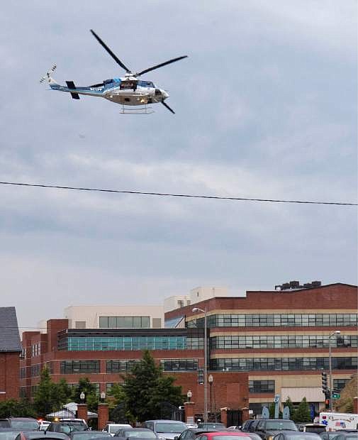 A U.S. Park Police helicopter circles the Washington Navy Yard Monday, Sept. 16, 2013, after a gunman was reported at the Navy Yard.  Earlier in the day, the U.S. Navy said it was searching for an active shooter at the Naval Sea Systems Command headquarters, where about 3,000 people work.  The exact number of people killed and the conditions of those wounded was not immediately known.  (AP Photo/Jacquelyn Martin)
