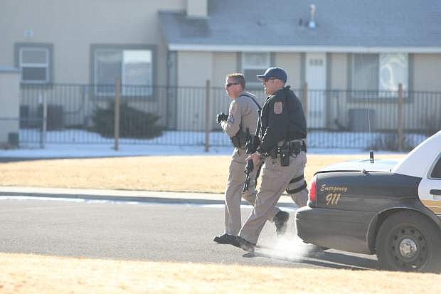 Douglas County law enforcement go door-to-door on Hussman Avenue in Gardnerville on Saturday morning during the search.