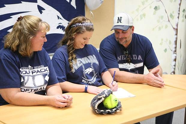 Vickie and Tom Purcell watch while Jennifer signs her letter of intent on Wednesday at Carson High School.