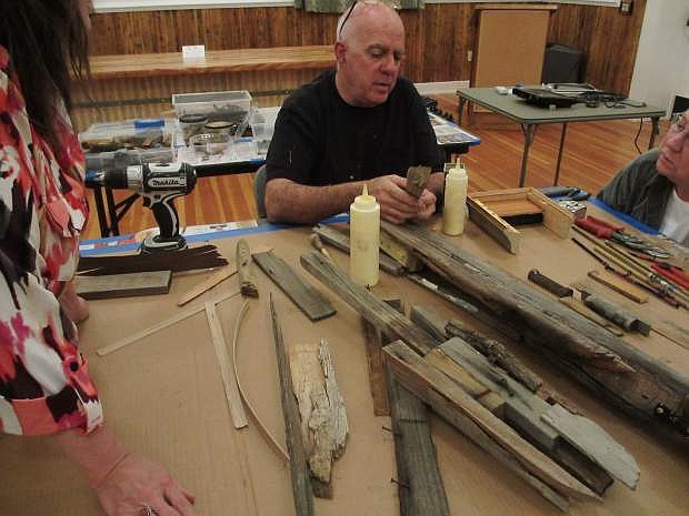 Artist Scott MacLeod works with a group to create a ship model art piece using found objects, such as brass bits, rusted iron, fishing poles, wire and salvaged wood. He is offering free art and writing workshops next month in Silver City.