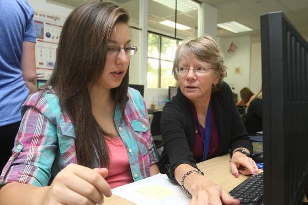 Silver State Charter Schooll teacher Nadine Branco reviews math class procedures with 15-year-old Deahnna Kai on Monday.