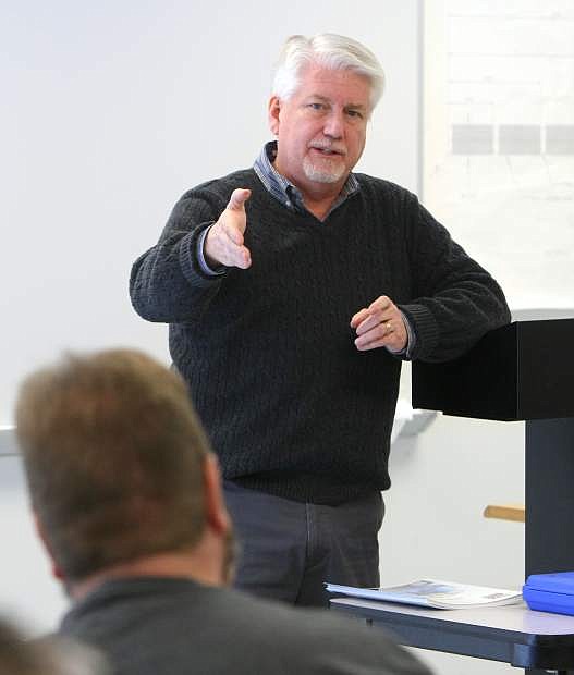 Larry Harvey with Click Bond Inc. talks with machine tool technology students on the first day of class on Monday.