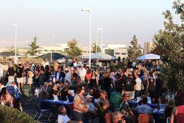 Smoke from California wildfires cover the mountains above as people enjoy Hopefest at the Carson-Tahoe Cancer Resource Center Friday night. For more photos, see page A4.