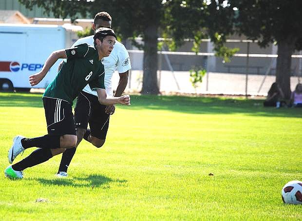 Fallon junior Corbin Waite, front, gets past a defender during the Wave&#039;s annual alumni soccer match on Wednesday at the Edward Arciniega Complex. Smoke from California wildfires has cancelled most of this week&#039;s practices and games.