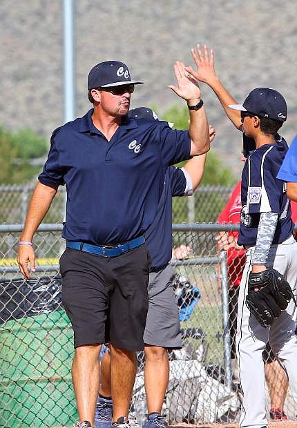 Carson 12&#039;s All-Star coach Joe Tierney high-fives Zaid Abdelhady after a good inning Friday against South Tahoe.