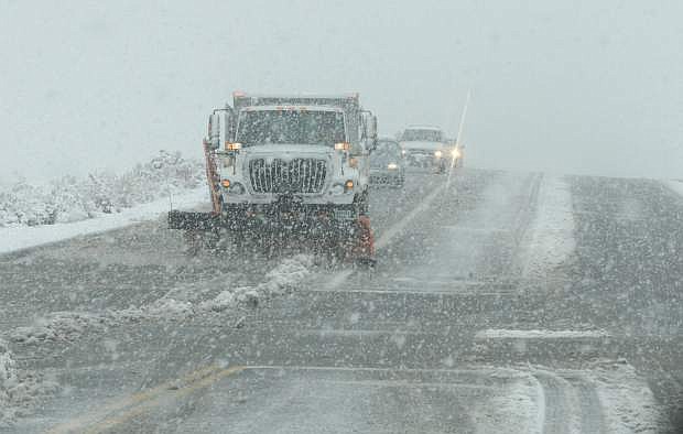 A snowplow works on Goni Road on Thursday morning.