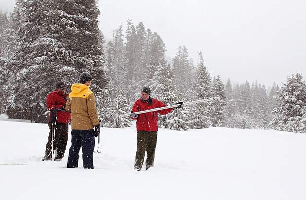 California Department of Water Resources snow surveys program chief Frank Gehrke (right) assesses the snowpack near Sierra-at-Tahoe Resort Tuesday.