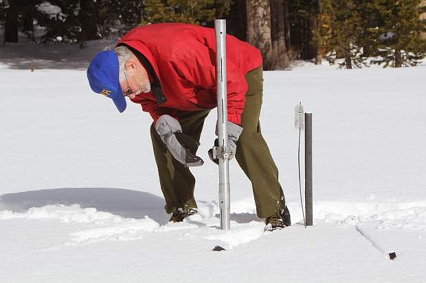 Frank Gehrke, chief of the California Cooperative Snow Surveys program, measures the snowpack at Phillips Station Wednesday, Dec. 30.