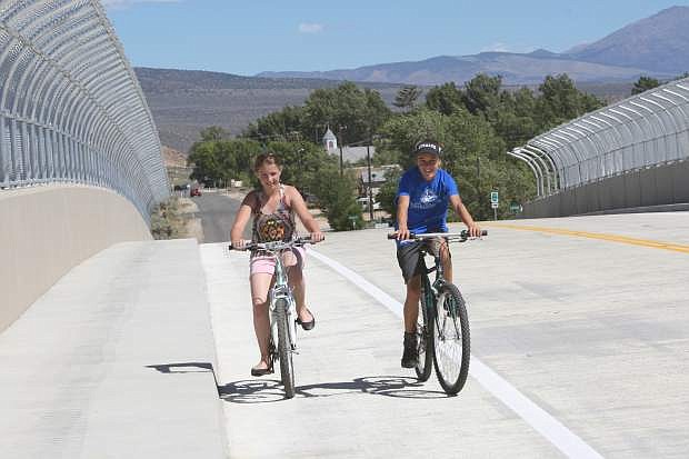 Amaya Mendeguia, 11, left, and Kailee Luschar, 12, ride their bicycles across the Snyder overpass which opened Friday in south Carson City.