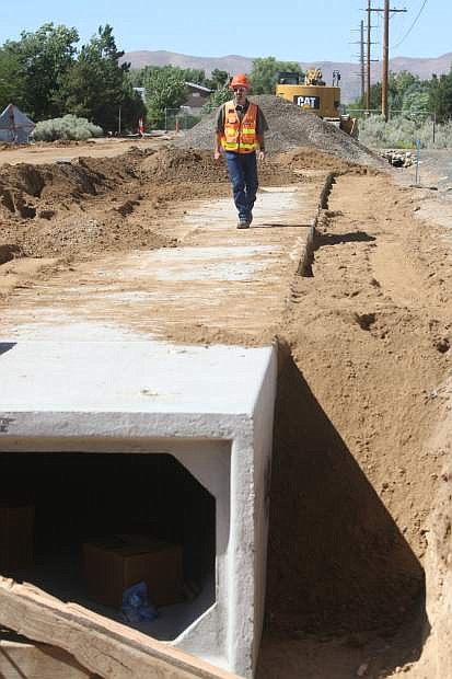 Resident engineer Stephen Lani checks out some of the underground work on a side street near Snyder Avenuey.