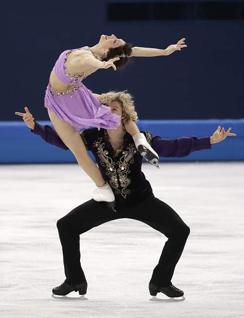 Meryl Davis and Charlie White of the United States compete in the ice dance free dance figure skating finals at the Iceberg Skating Palace during the 2014 Winter Olympics, Monday, Feb. 17, 2014, in Sochi, Russia. (AP Photo/Bernat Armangue)