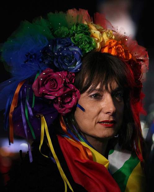 Vladimir Luxuria, a former Communist lawmaker in the Italian parliament and prominent crusader for transgender rights, walks in Olympic Park at the 2014 Winter Olympics, Monday, Feb. 17, 2014, in Sochi, Russia. Luxuria said she was detained by police at the Olympics after being stopped while carrying a rainbow flag that read in Russian: &quot;Gay is OK.&quot; Police on Monday denied this happened. (AP Photo/Steve Barker)