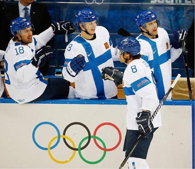 Finland forward Teemu Selanne (8) is congratulated by his teammates after scoring a goal against Norway during the 2014 Winter Olympics men&#039;s ice hockey game at Shayba Arena, Friday, Feb. 14, 2014, in Sochi, Russia. (AP Photo/Petr David Josek)