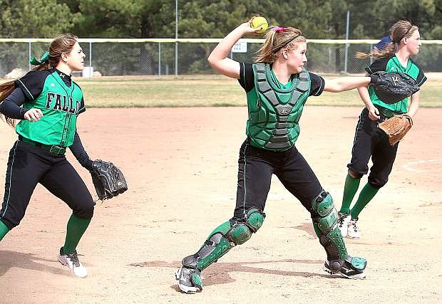 Fallon catcher Megan McCormick, middle, throws to first during a game against Truckee on Monday as Miranda Ford, left, and Caitlyn Welch look on. The Lady Wave visits Spring Creek today and Saturday.