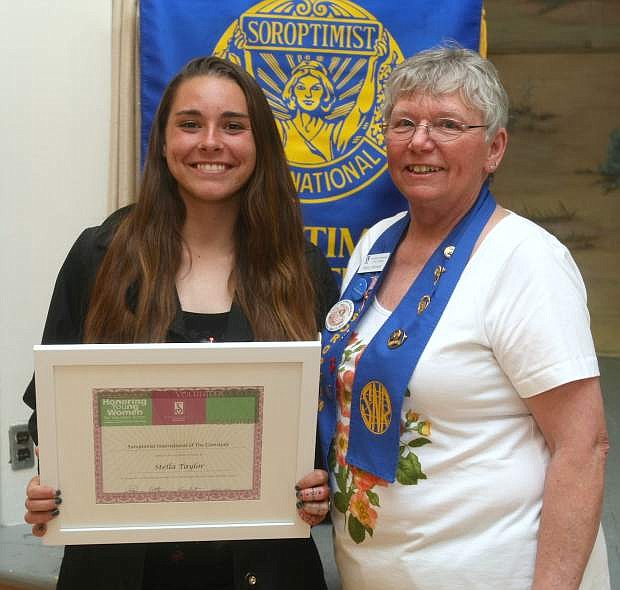 Sharon Atkinson, president of Soroptimist International of the Comstock presents Dayton High School student Stella Taylor with the Violet Richardson award.