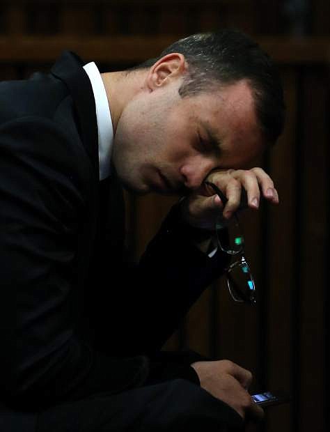 Oscar Pistorius gestures as he listens to evidence by a pathologist in court in Pretoria, South Africa, Monday, April 7, 2014. Pistorius is charged with murder  for the shooting death of his girlfriend Reeva Steenkamp, on Valentines Day 2013. (AP Photo/Themba Hadebe, Pool)