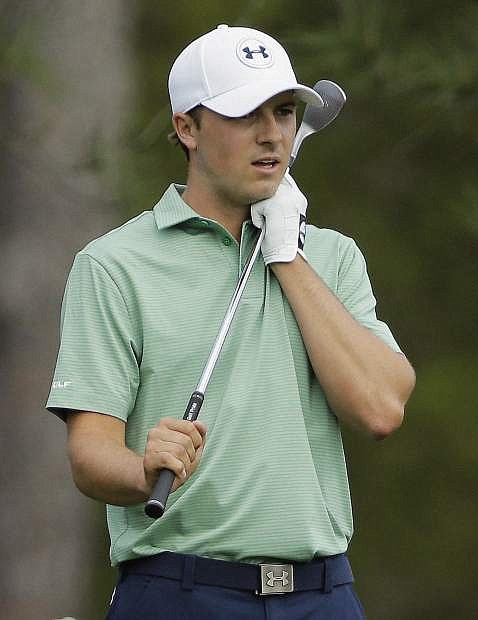 Jordan Spieth clutches his club after his approach shot on the eighth hole during the fourth round of the Masters golf tournament Sunday, April 13, 2014, in Augusta, Ga. (AP Photo/David J. Phillip)