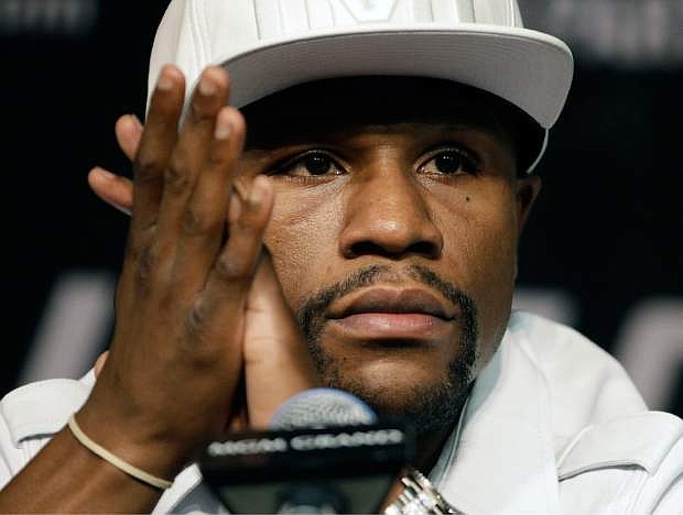 Boxer Floyd Mayweather Jr. attends a news conference Wednesday, Sept. 10, 2014, in Las Vegas. Mayweather Jr. is scheduled to fight Marcos Maidana in a welterweight title fight Saturday in Las Vegas. (AP Photo/John Locher)