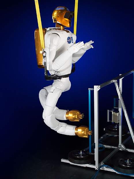 This Nov. 13, 2013 photo made available by NASA shows the Robonaut with legs at a lab in Houston. Each leg, 4 feet, 8 inches long when straight, has seven joints. Instead of feet, there are grippers. Each gripper, or foot, has a light, camera and sensor for building 3-D maps. (AP Photo/NASA, Bill Stafford, James Blair)