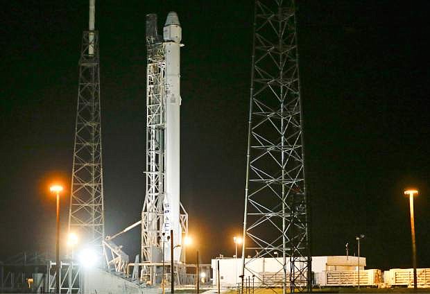 The Falcon 9 SpaceX rocket stands ready for launch on complex 40 at the Cape Canaveral Air Force Station in Cape Canaveral, Fla., Friday, Jan. 9, 2015. SpaceX is scheduled to launch its fifth operational resupply mission to the International Space Station for early Tuesday morning. (AP Photo/John Raoux)