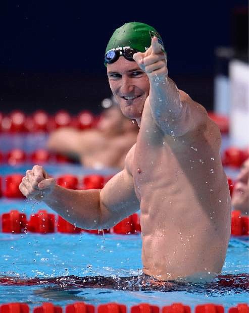 South Africa&#039;s Cameron Van Der Burgh celebrates after winning the gold medal in the Men&#039;s 50m breaststroke final at the FINA Swimming World Championships in Barcelona, Spain, Wednesday, July 31, 2013.  (AP Photo/Manu Fernandez)