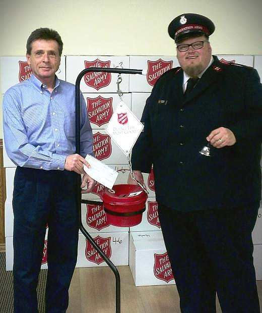 Joe Locurto, business development manager at Spherion Staffing Services in Carson City, presents a $1,000 check to Lt. Mark Cyr of Salvation Army.