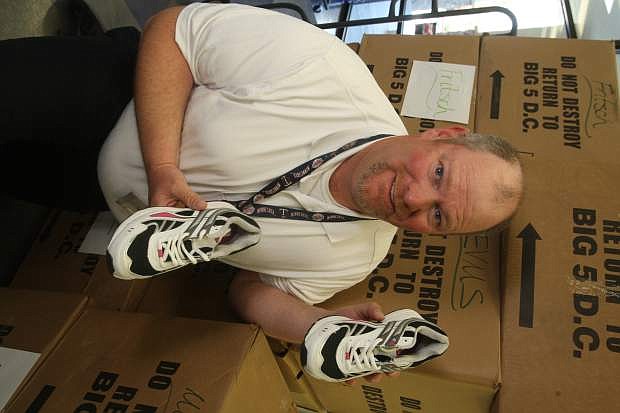 Fremont Elementary School vice-principal Dan Brown displays a pair of shoes for the Step into Spring shoe program.