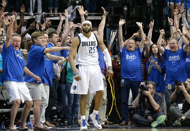 Fans cheer as Dallas Mavericks guard Vince Carter stands in the corner after he made the game-winning 3-point basket at the buzzer in the fourth quarter against the San Antonia Spurs in Game 3 in the first round of the NBA basketball playoffs in Dallas, Saturday, April 26, 2014.  The Mavericks won 109-108. (AP Photo/LM Otero)