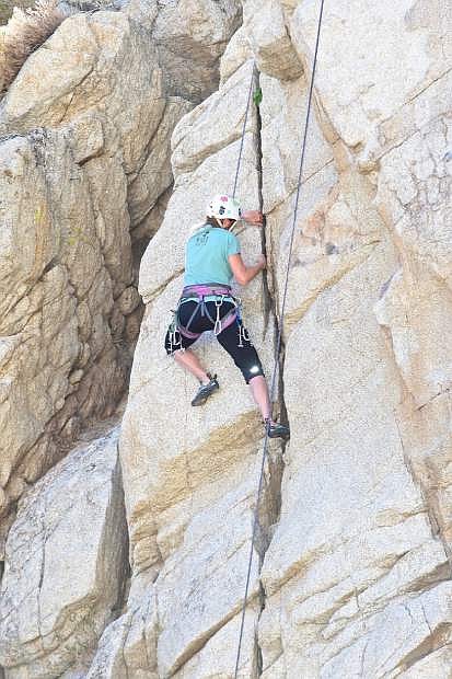 Lara Pearson of Kings Beach ascends a rock wall off Old Clear Creek Rd. Wednesday afternoon.