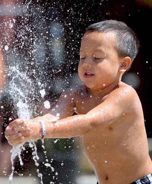Spencer Boholst, 5, plays in the splash pad at the Bob McFadden Plaza on Tuesday afternoon.