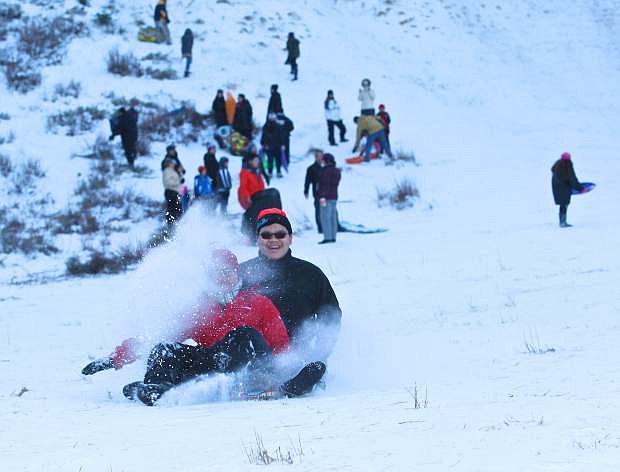 Andrew Lin, 14, and his brother Kevin, 18, from San Francisco enjoy some sledding on Spooner Summit Saturday afternoon.