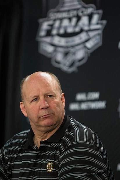 Boston Bruins head coach Claude Julien listens during an NHL hockey news conference Friday, June 14, 2013, in Chicago. The Bruins trail the Chicago Blackhawks 1-0 in the best-of-seven games Stanley Cup final series. Game 2 is scheduled for Saturday in Chicago.  (AP Photo/Scott Eisen)