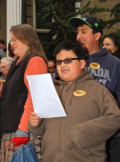 Matthew Barragen, 11, sings &#039;Home Means Nevada&#039; on the steps of the Capitol building Thursday morning.
