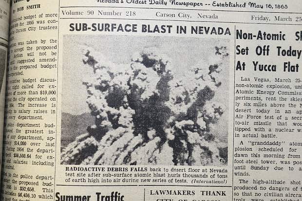 March 25, 1955: Radioactive debris falls back to desert floor at Nevada test site after sub-surface atomic blast hurls thousands of tons of earth high into air during new series of tests. (International)