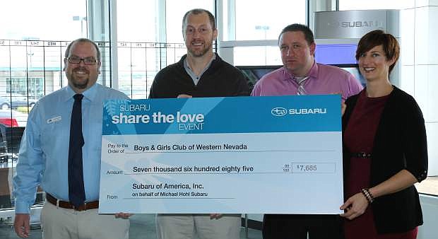 Katie Leao, executive director for the Boys &amp; Girls Clubs of Western Nevada is presented a check for $7,685 from Subaru representatives, from left, Nick Reinhardt, sales manager; Shawn Bachelder, district sales manager; and Bryan Worch, general sales manager.