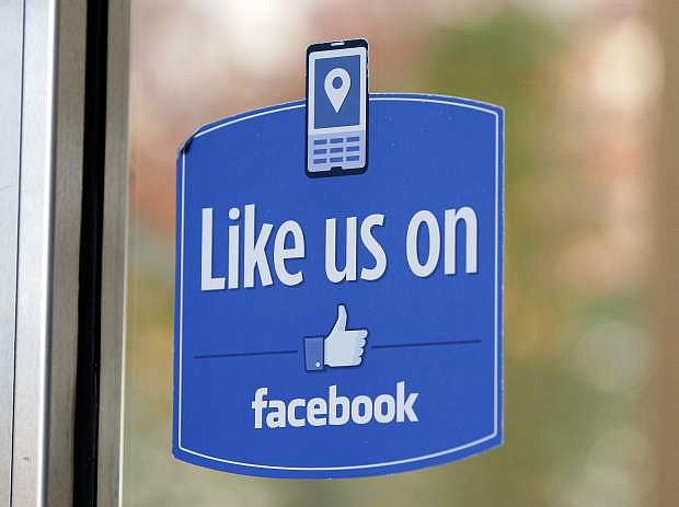 FILE - In this Dec. 13, 2011 file photo, a sign with Facebook&#039;s &quot;Like&quot; logo is posted at Facebook headquarters near the office for the company&#039;s User Operations Safety Team in Menlo Park, Calif.  Celebrities, businesses and even the U.S. State Department have bought bogus Facebook likes, Twitter followers or YouTube viewers from offshore &quot;click farms,&quot; where workers tap, tap, tap the thumbs up button, view videos or retweet comments to inflate social media numbers. (AP Photo/Paul Sakuma, File)