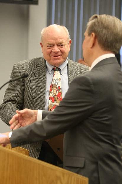 Carson City Manager Larry Werner receives a plaque for his retirement from Mayor Bob Crowell on Thursday.