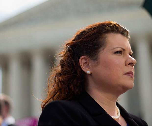 Lori Windham, the attorney representing Hobby Lobby, stands outside the Supreme Court in Washington, Monday, June 30, 2014, following the decision on the Hobby Lobby case. The Supreme Court says corporations can hold religious objections that allow them to opt out of the new health law requirement that they cover contraceptives for women. (AP Photo/Pablo Martinez Monsivais)