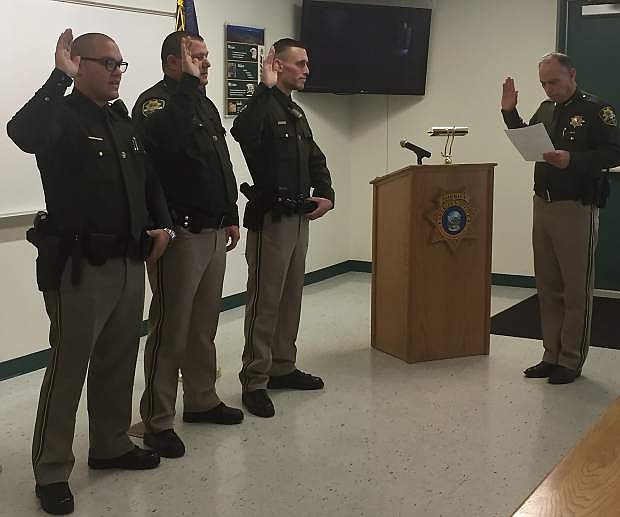 Deputies Jeremy Garcia, Dennis Moore and Cody Bindley get sworn in by Carson City Sheriff Ken Furlong Friday afternoon at the Sheriff&#039;s Office.