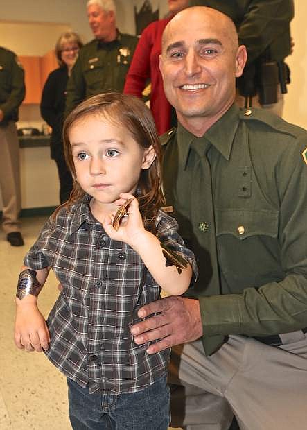 Reserve Sheriff Daniel Gelbman and his 2 1/2-year-old son Daxton at Thursday&#039;s swearing in ceremony.