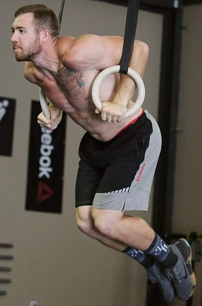 Sweeney performs a muscle-up.