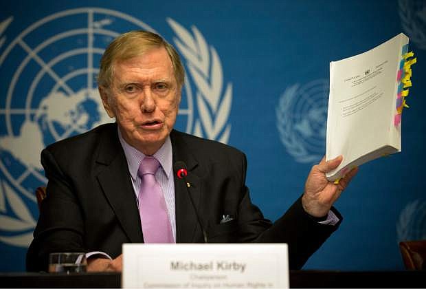 Retired Australian judge Michael Kirby, chairperson of the commission of Inquiry on Human Rights in the Democratic People&#039;s Republic of Korea, shows the commission&#039;s report during a press conference at the United Nations in Geneva, Switzerland, Monday, Feb. 17, 2014. A U.N. panel has warned North Korean leader Kim Jong Un that he may be held accountable for orchestrating widespread crimes against civilians in the secretive Asian nation. Kirby told the leader in a letter accompanying a yearlong investigative report on North Korea that international prosecution is needed &quot;to render accountable all those, including possibly yourself, who may be responsible for crimes against humanity.&quot; (AP Photo/Anja Niedringhaus)