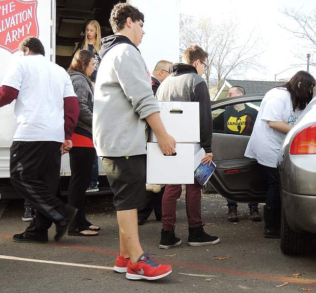Salvation Army distributed 300 turkeys and other Thanksgiving food Monday with the help of students mainly from Silver State Charter School.