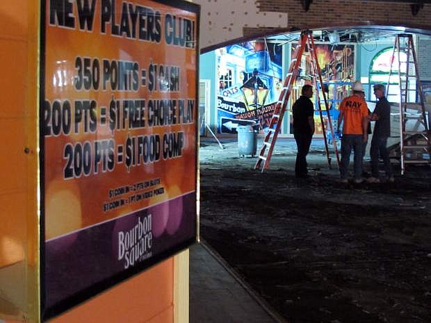 This Sept. 21, 2015 photo shows crews working inside the shuttered Bourbon Square Casino that is being renovated as part of a housing-retail project at Victorian Square in Sparks, Nev.  The city of Sparks has launched an ambitious urban renewal project with downtown apartments and retail space fueled by the dramatic growth in jobs and housing anticipated in the years ahead with the arrival of Tesla Motors, Switch and others (AP Photo/Scott Sonner)
