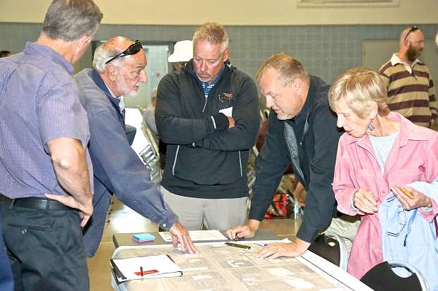 South Carson Street meeting attendees take a look at projet plan maps Thursday evening at Fuji Park.