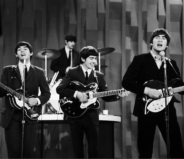 FILE - In this Feb. 9, 1964 file photo, The Beatles , from left, Paul McCartney, Ringo Starr on drums, George Harrison and John Lennon, perform on the CBS &quot;Ed Sullivan Show&quot; in New York.  The Beatles made their first appearance on &quot;The Ed Sullivan Show,&quot; America&#039;s must-see weekly variety show, on Sunday, Feb. 9, 1964. And officially kicked off Beatlemania. (AP Photo/Dan Grossi/ File)