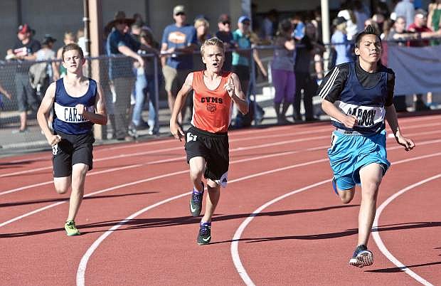 Carson Valley Middle School&#039;s Hunter Reed is flanked by Carson&#039;s Luis Valdez (right) and Garrett Tibma in a heat of the 8th grade boy&#039;s 400-meter run Wednesday.