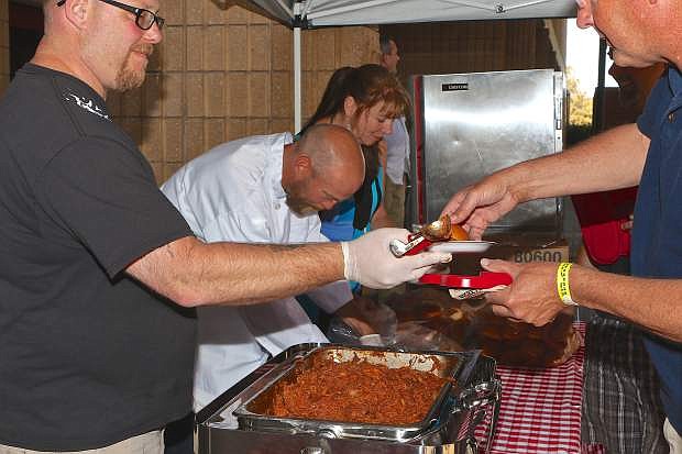 Carson Nugget executive chef David Sellers serves pulled pork sandwiches.